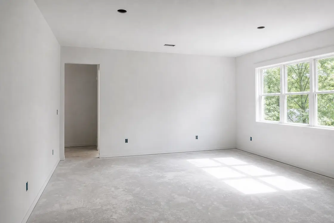 Bright finished interior room with smooth paint-ready drywall